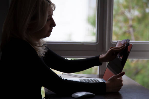 istock Young woman cleaning laptop 1285110222