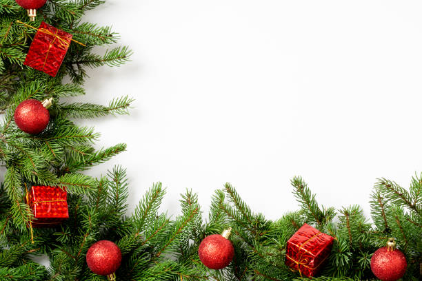 istock Christmas background. Red decorations on spruce branches on a white background. Christmas Flatly. Top view from copyspace 1285110226