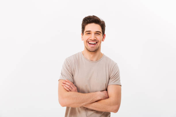 istock Image of happy smiling man 30s with bristle posing on camera with hands crossed, isolated over white background 1285113367