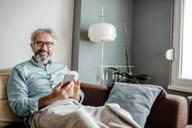 istock Senior man at home using mobile phone 1285113542