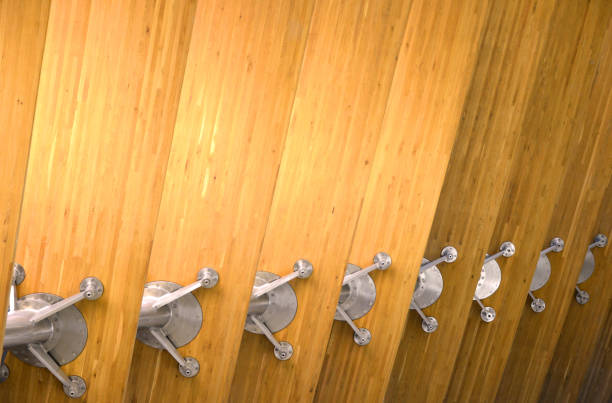Beams of glued laminated wood connected with steel spider fitting -  glulam is a structural material is obtained by gluing several planks of wood in which the yarn is substantially parallel (lamstock). It allows the construction of large parts and specific shapes which could not have been obtained by using the same material without transformation. There is a large improvement of the mechanical resistance compared to a piece of solid wood.