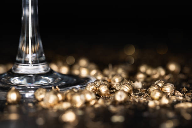 Shining golden particles abstract background. Blurred bokeh background of gold dust particles slowly floating in the air. Magical fairy background. festive golden dark background.