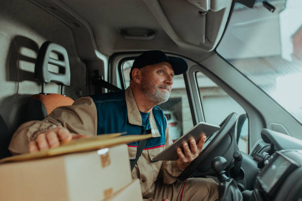 istock Delivery man driving his van and delivering shipments. He is checking order on digital tablet 1285115487