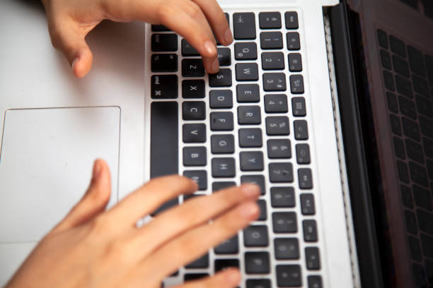 istock Fingers working on keyboard on laptop 1285118485