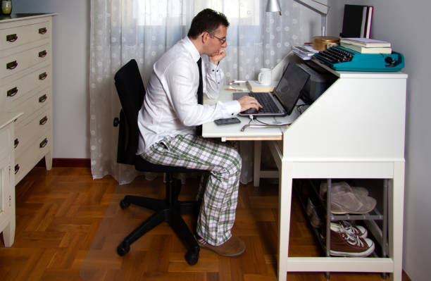 istock Man teleworking wearing shirt, tie and pajama pants 1285120264