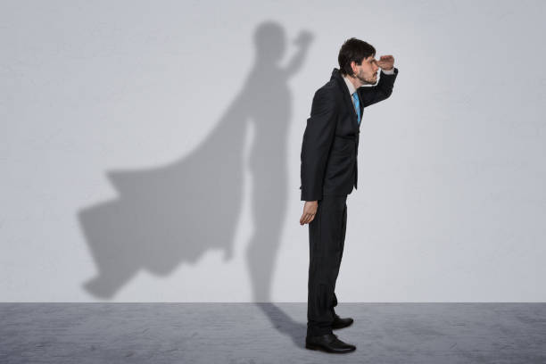 istock Businessman in suit with shadow as superhero. 1285121222
