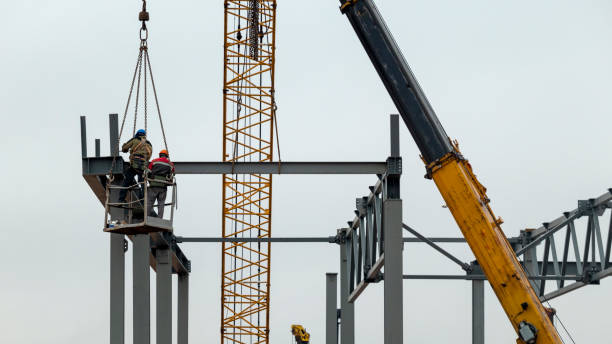 istock two workers at a construction site are assembling the frame of a building at a high altitude 1285122419