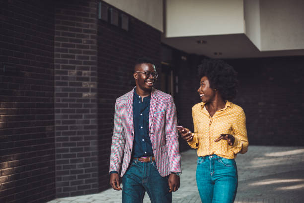 Young adult hipsters smiling, walking trough passage.