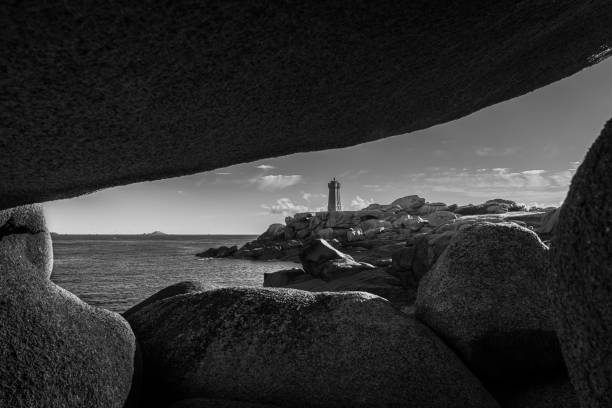 The pink granite lighthouse of Ploumanac'h (Brittany, France) stands in the middle of the chaotic rock formations formed by the erosion of cooled magma then shaped by the rain, salty sea spray and wind. Its name comes from the Breton \
