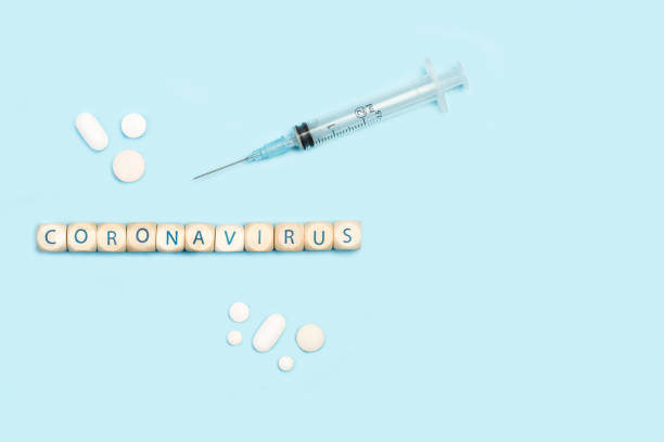 istock Coronavirus word made with wooden letter cubes with a syringe 1285123005