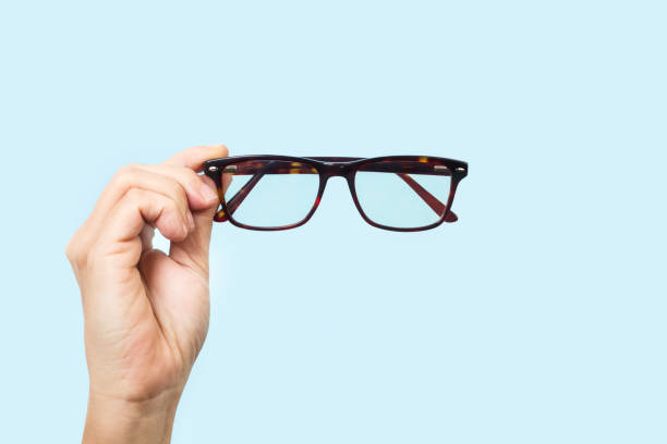 istock Woman hand holding brown eyeglasses 1285123089