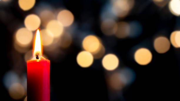 istock a red candle burns in the foreground 1285123102