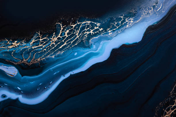istock Fluid Art. Liquid Metallic Gold in abstract blue wave. Marble effect background or texture 1285123201