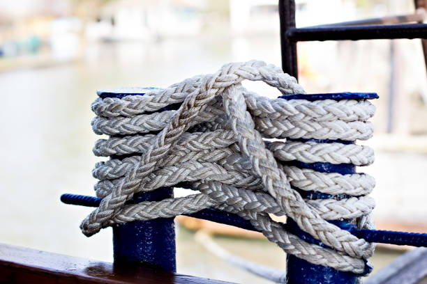 istock Mooring rope with a knotted end tied around a cleat on a pier 1285124106