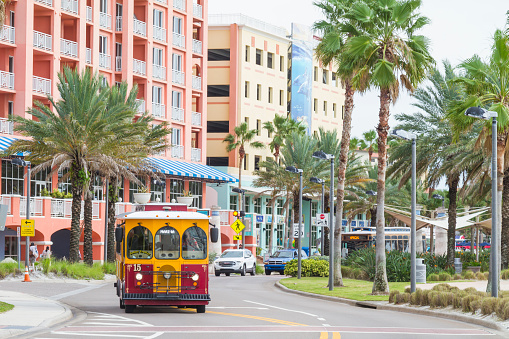 September 20, 2020 - Clearwater Beach, St. Petersburg, Florida, United States of America USA: A general landscape view of Clearwater Beach, on main focus a recreated trolley bus, this kind of bus are the public transportation around the ClearWater City. This idea are followed by another important touristic cities to recreated the old fashioned trolley cables car. No ones at the streets because this picture was taken  during Covid-19 Corona Virus Pandemic illness breakdown.

Clearwater Beach is one hour driving from Tampa and four hours driving from Miami.