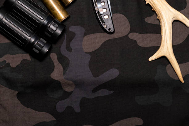 istock Hunting background. On camouflage background flat lay with hunting accessories. Top view with place for text 1285128761