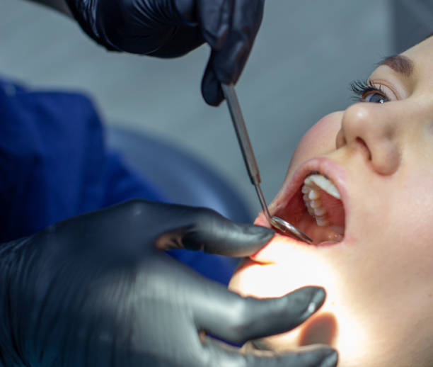 istock A woman at a dentist's appointment to replace arches with braces. 1285129816