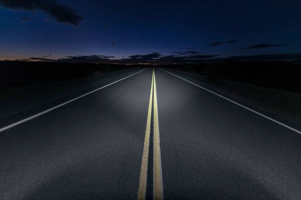 Mojave Desert Road Route 66 Night Quiet Mojave desert portion of Route 66 at night in Southern California. empty road stock pictures, royalty-free photos & images