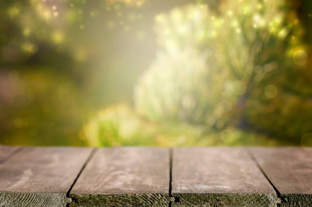 istock Empty wooden table in front of abstract green blurred background. Wood table top on blur background. Mock up for display of product 1285131861