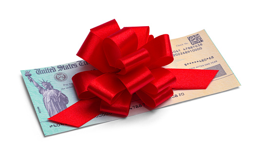 Federal Tax Return Check with Red Ribbon Bow.