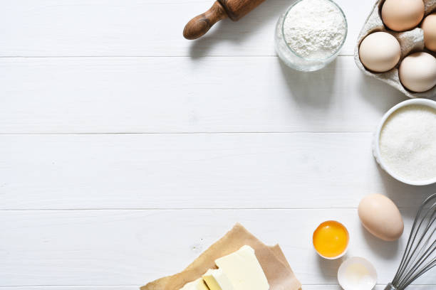 istock Baking ingredients: flour, eggs, sugar with a rolling pin on a light white wood background. With copy space. 1285132739