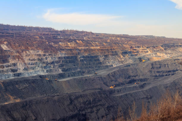 istock Huge iron ore quarry with working dump trucks and excavators 1285132861