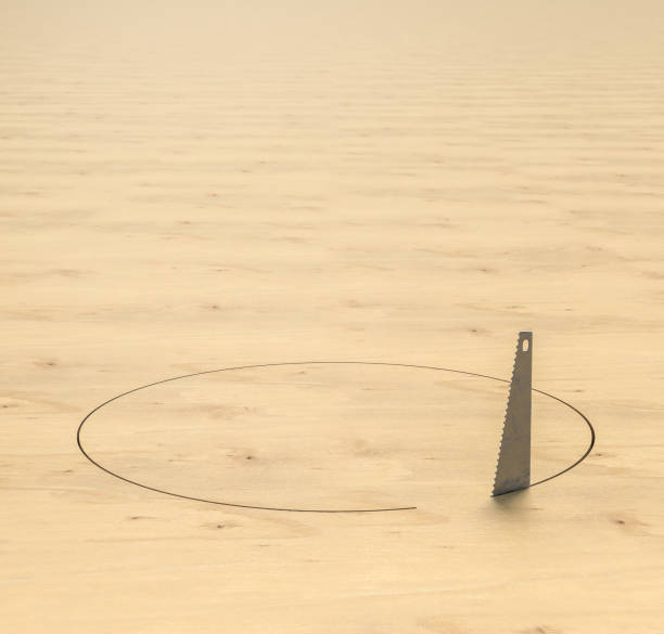 saw cuts a circular hole in a wooden floor.