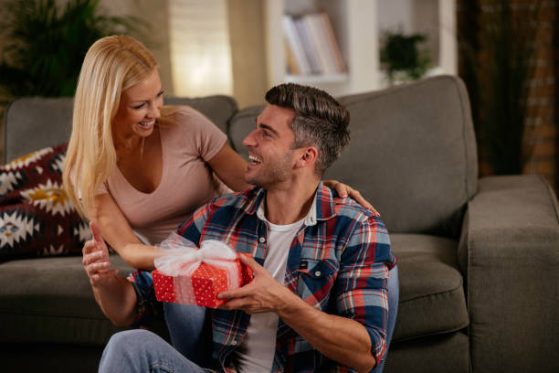 istock Young romantic couple holding present stock photo 1285135810