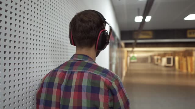 Rare view of a man practicing with gun in the shooting range