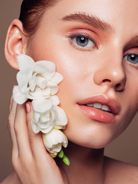 istock Beautiful woman with flower 1285139776