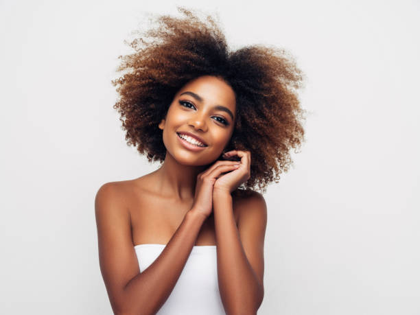 istock _Beautiful smiling girl with curly hairstyle 1285140083