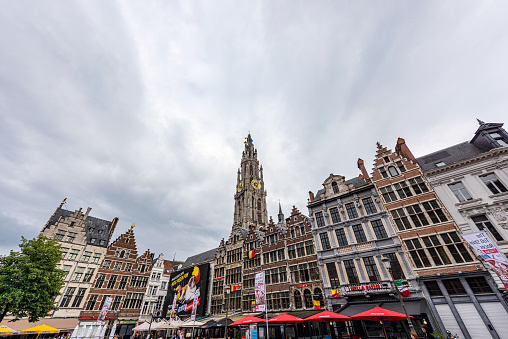 Bruges, Belgium - May 4, 2011: Tourists walk in front of the Belfort Tower in Bruges, Belgium on May 4, 2011