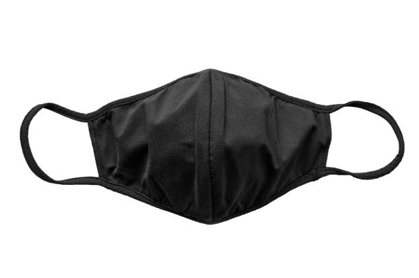 istock Black protective fabric face mask on a white background, shallow depth of sharpnesse 1285141060