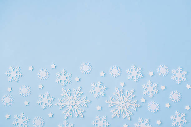 istock Flat lay border with christmas balls and snowflakes on a blue background 1285141696