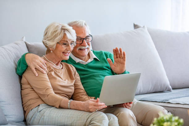 istock Happy senior couple having video call on laptop. 1285142869