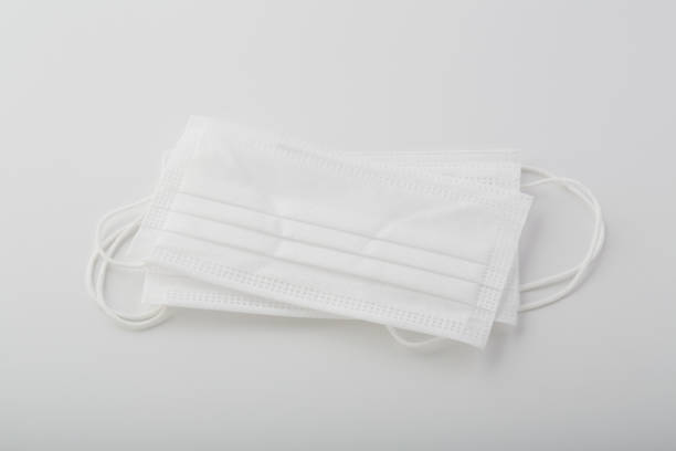 istock Group of white surgical protective face masks on white background 1285144127