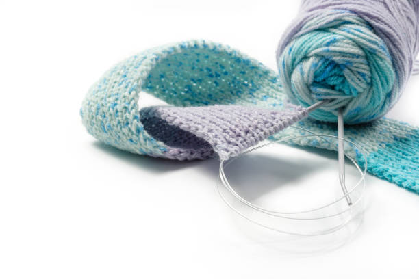 istock Knitting and clew of yarn isolated on white 1285144227