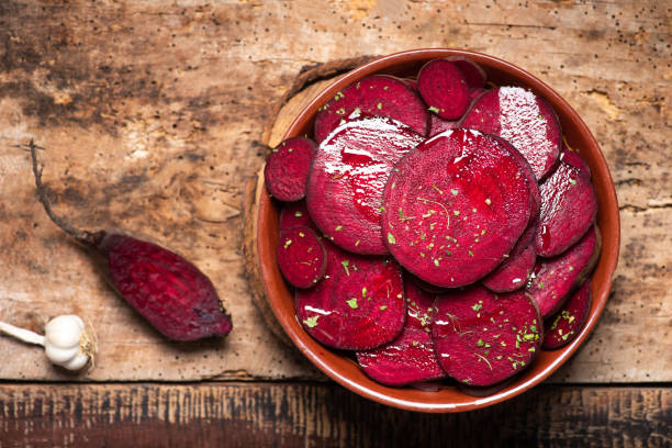 Beetroot salad with parsley in a bowl Beetroot salad with parsley in a bowl on a rustic wooden table common beet photos stock pictures, royalty-free photos & images