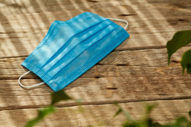 istock Medical protective face mask on wooden surface 1285144984