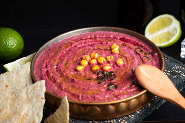 istock Healthy vegan hummus with beet root in a bowl top view 1285145289