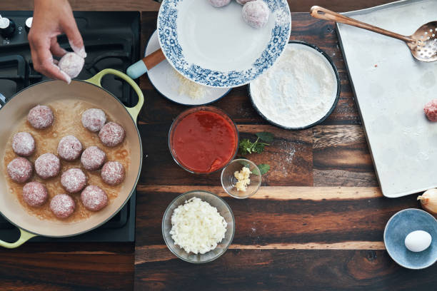 istock Preparing Meatballs with Tomato Sauce in a Pan 1285145317