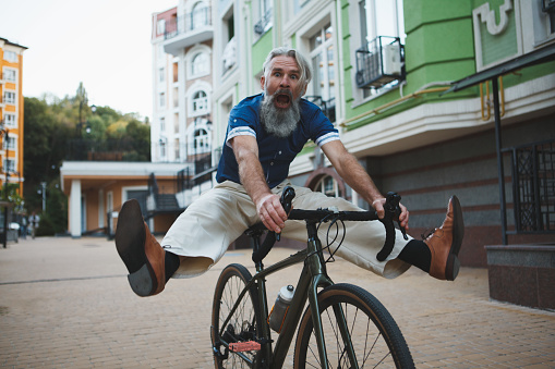 Photo of a man riding his cargo bike and running errands around the city early in the morning.