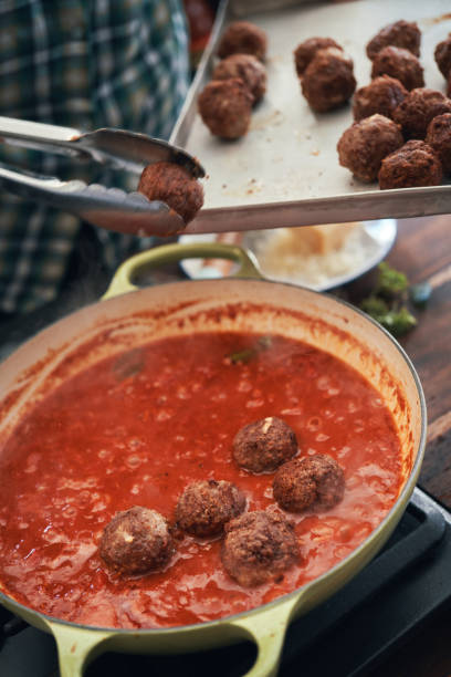 istock Preparing Meatballs with Tomato Sauce in a Pan 1285146490