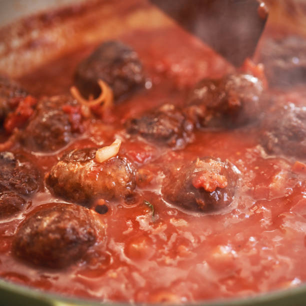 istock Preparing Meatballs with Tomato Sauce in a Pan 1285147093