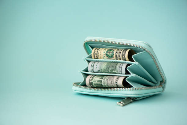 istock turquoise wallet with money on a light background 1285148294