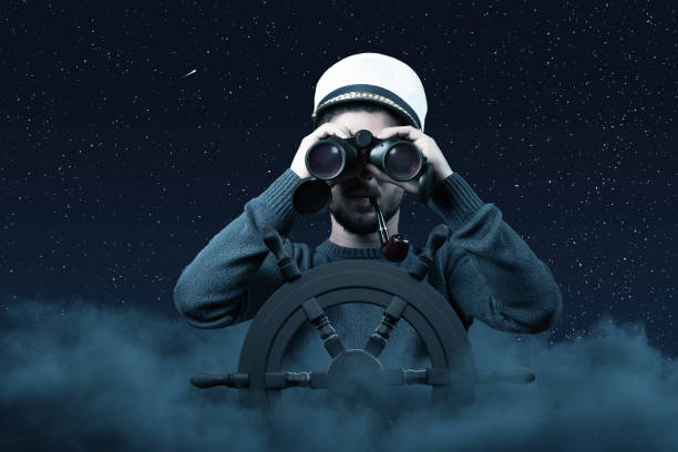 istock helmsman with binoculars and cap over clouds viewing to the starry sky 1285148484