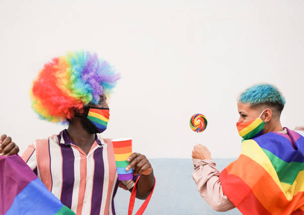 istock Multiracial firends dance at gay pride parade with rainbow flag 1285149474