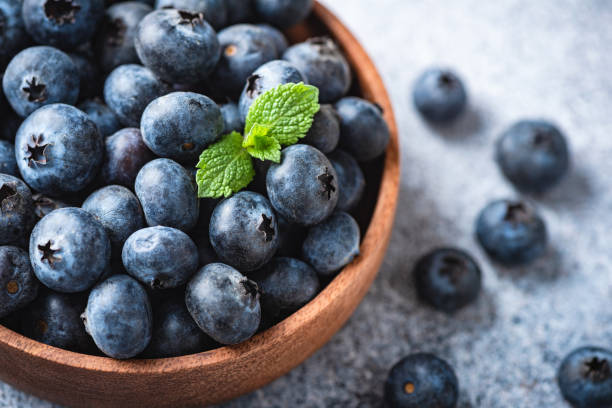 istock Organic blueberries in a wooden bowl 1285150662