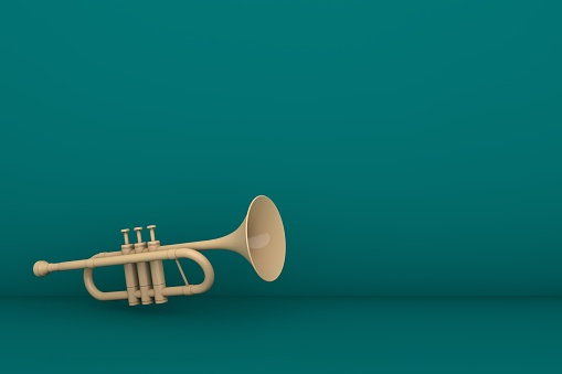 Photograph of a brass horn and music.