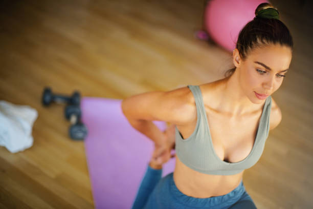 istock Young woman stretching legs at the gym. 1285151992